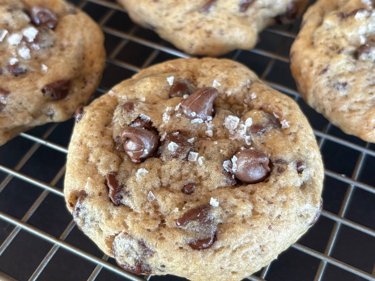 Sourdough chocolate chip cookies cooling on a wire rack